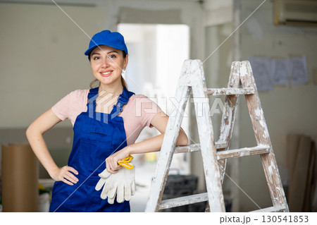 Female worker posing in apartment being renovated Female worker posing in apartment being renovated 130541853