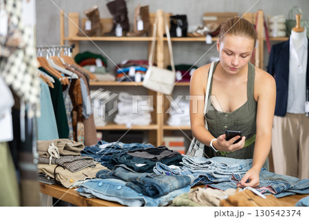 woman scans a mobile phone on pants woman scans a mobile phone on pants 130542374