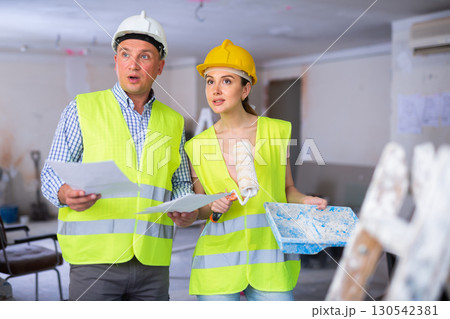 Foreman and woman painter discussing design of room Foreman and woman painter discussing design of room 130542381