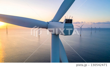 Sustainable wind turbines generate renewable energy at sunset over Sustainable wind turbines generate renewable energy at sunset over 130542471