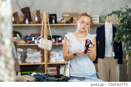 Teenage girl choosing high heel shoes in store 130542773