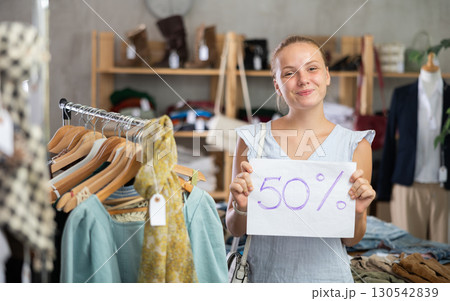Woman with a sign 50 percentages discount 130542839