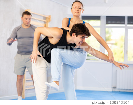 Guy paired up with woman to perform effective impact on pain points while learning self-defense. Guy paired up with woman to perform effective impact on pain points while learning self-defense. 130543104
