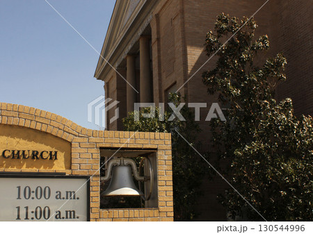 Bell and Brick Sign in Front of Historic Methodist Church in Rural East TX 130544996