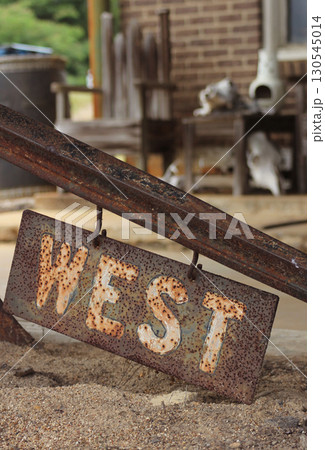 Metal Sign With Word West Outside of Rural Store in Texas 130545014