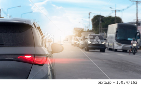 Rear side of car with speed light of brake. on the car with dust of soil all over the surface. Opposite of road with other cars stop in the junction. traffic in the upcountry. 130547162