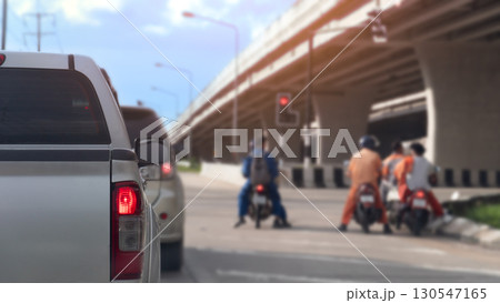 Rear side of pickup car with turn on brake light. Stop on the road by traffic red control in the junction. Stop with together other car and motorcycle. Under concrete bridge level. Evironment at day. Rear side of pickup car with turn on brake light. Stop on the road by traffic red control in the junction. Stop with together other car and motorcycle. Under concrete bridge level. Evironment at day. 130547165