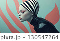 Beautiful woman wearing black latex costume with striking red lips portrait 130547264