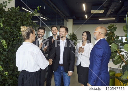 Business handshake and warm welcome between colleagues in bright modern office Business handshake and warm welcome between colleagues in bright modern office 130547753
