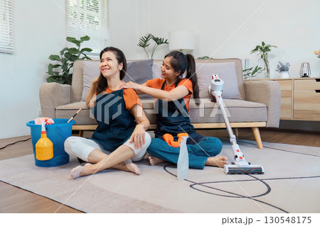 Housekeeping service with two women enjoying teamwork while cleaning. Housekeeping service with two women enjoying teamwork while cleaning. 130548175