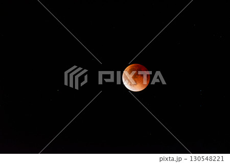 Breathtaking Blood Moon During a Total Lunar Eclipse Against a Starry Sky 130548221