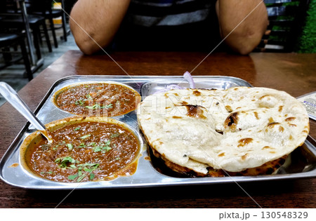 Indian Restaurant Meal with Naan and Curry Indian Restaurant Meal with Naan and Curry 130548329