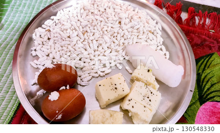Traditional Indian Sweets and Offerings on a Steel Plate 130548330