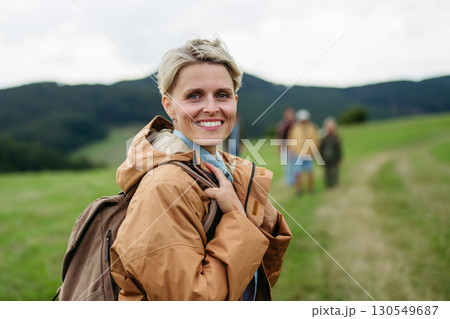 Portrait of beautiful woman during family hiking trip in nature. 130549687