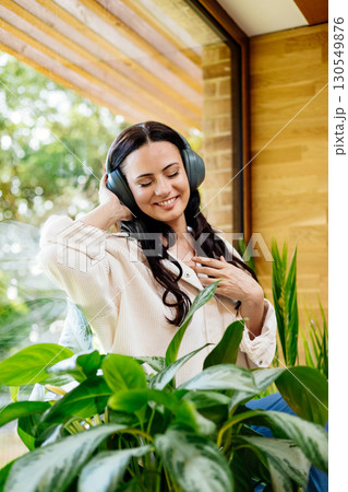 Relaxed woman enjoying free time, listening to music. Relaxed woman enjoying free time, listening to music. 130549876