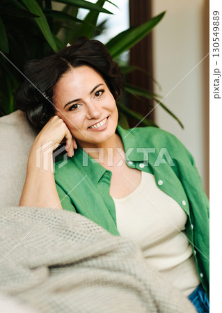 Portrait of woman with hair rollers during slow morning. 130549889
