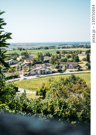 Scenic view of a rural French village surrounded by farmland and greenery under a clear sky. Return to the countryside, neo-ruralism, remote work migration, slow living 130550884