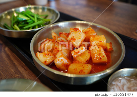 Traditional Korean Radish Kimchi and Fresh Green Onion Side Dish in Brass Bowl Traditional Korean Radish Kimchi and Fresh Green Onion Side Dish in Brass Bowl 130551477