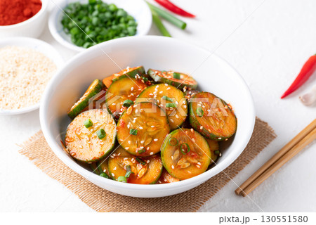 Korean cucumber salad (Oi muchim) in bowl on white background, Korean side dish Korean cucumber salad (Oi muchim) in bowl on white background, Korean side dish 130551580