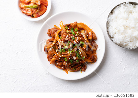 Korean stir fried spicy pork (Bulgogi) with cooked rice and kimchi on white background, Top view 130551592