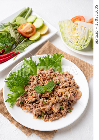 Local Thai food, Spicy minced pork salad (Larb Moo) eating with fresh vegetables on white background 130551605