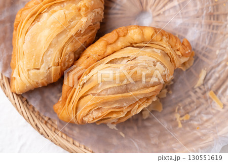 Top view of curry puff stuffed with chicken or sweet potatoes in basket, Thai snack food style Top view of curry puff stuffed with chicken or sweet potatoes in basket, Thai snack food style 130551619