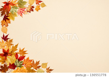 Autumn leaves on beige background Autumn leaves on beige background 130551778
