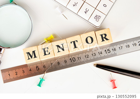 The MENTOR concept word is assembled from wooden cubes on a white surface. The concept of business and development The MENTOR concept word is assembled from wooden cubes on a white surface. The concept of business and development 130552095