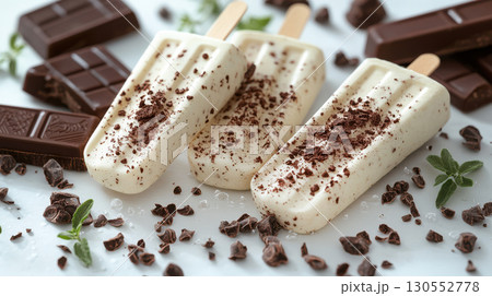 White, dark and milk chocolate on stick, creamy with almond and hazelnuts. Modern minimal food photography summer dessert vibes. 130552778