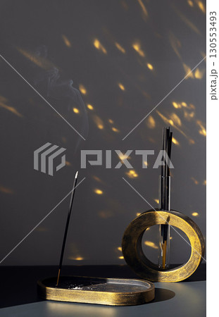 Incense stick burning creating smoke. Spiritual aromatherapy for relaxation, meditation, yoga. Incense stick burning creating smoke. Spiritual aromatherapy for relaxation, meditation, yoga. 130553493