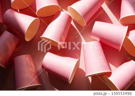 Numerous pink paper cups scattered on light pink background with strong shadows. Numerous pink paper cups scattered on light pink background with strong shadows. 130553498