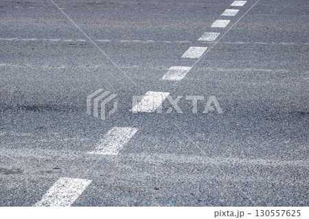 This image shows a closeup of a road with visible white lines 130557625