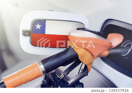 The flag of Chile on the hatch of the gas tank of a car at a gas station in close-up. High or low prices at Chilean gas stations. Problems with the fuel quality of gasoline and diesel fuels and their 130557916