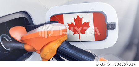 The Canadian flag is on the lid of the gas tank of a car at a gas station. Gasoline and diesel are Canadian issues. High prices for diesel fuel, gasoline and gas at gas stations in Canada and Ottawa. The Canadian flag is on the lid of the gas tank of a car at a gas station. Gasoline and diesel are Canadian issues. High prices for diesel fuel, gasoline and gas at gas stations in Canada and Ottawa. 130557917