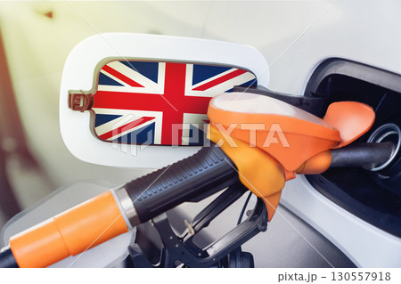 The flag of great Britain on the hatch of the gas tank of a car at a gas station. Gasoline and diesel fuel in britain. High prices for diesel fuel, gasoline and gas at gas stations in British. The flag of great Britain on the hatch of the gas tank of a car at a gas station. Gasoline and diesel fuel in britain. High prices for diesel fuel, gasoline and gas at gas stations in British. 130557918