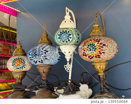Colorful mosaic lamps with intricate star patterns and vibrant glass design. Cultural heritage, traditional craft, and decorative illumination in lifestyle and interior art. Colorful mosaic lamps with intricate star patterns and vibrant glass design. Cultural heritage, traditional craft, and decorative illumination in lifestyle and interior art. 130558084