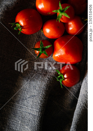 Red tomatoes on grey kitchen towel 130558406