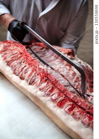 Cutting a pig on the butcher block 130558698