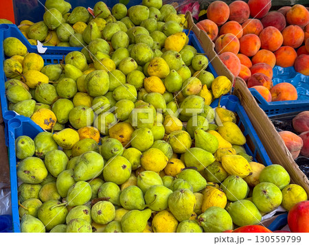 Pears displayed in crate at open market. Agriculture, nutrition, and seasonal fruit harvest representing crop abundance, rural supply, and healthy organic lifestyle. 130559799