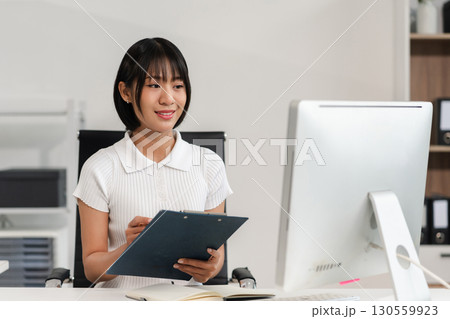 Businesswoman analyzing financial graphs, calculating company expenses, and planning investments, corporate, accounting, and economic strategy. 130559923