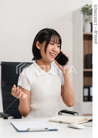 women talk mobile phones appointment reminders in calendar on interface. working on laptop computers, online business. 130559928