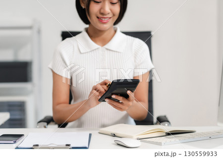 Business woman or financial data analysts working with laptop and calculator show increase market share, growth of profit investment at home office. 130559933