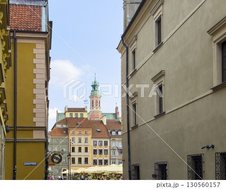 Warsaw Poland May 20 2025 Narrow street view leading to Old Town square, with colorful historic Warsaw Poland May 20 2025 Narrow street view leading to Old Town square, with colorful historic 130560157