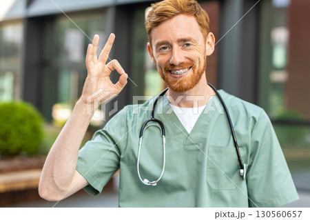 Doctor with beard and stethoscope showing ok symbol Doctor with beard and stethoscope showing ok symbol 130560657