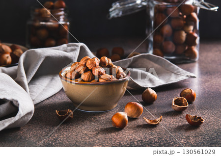 High-calorie peeled hazelnuts in a bowl on the table High-calorie peeled hazelnuts in a bowl on the table 130561029