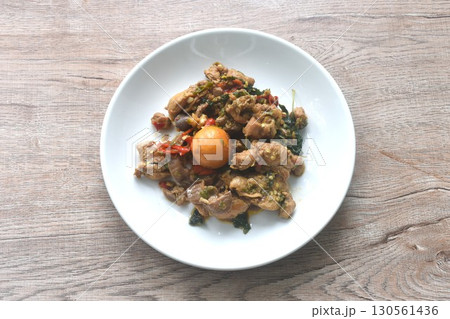 spicy chili stir-fried chicken meat and gizzard couple egg with basil leaf on plate spicy chili stir-fried chicken meat and gizzard couple egg with basil leaf on plate 130561436