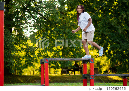 Girl playing at the playground and looking happy and energized 130562456