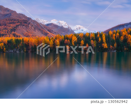 Nature. Mountain lake at dawn. Bright sky and clouds. Reflections on the water surface. 130562942