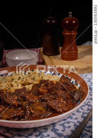 Hungarian goulash with spaetzle: savory beef stew and egg noodles dish Hungarian goulash with spaetzle: savory beef stew and egg noodles dish 130563891