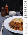 Delicious hungarian goulash with spaetzle, a traditional stew, served on a white plate 130563905